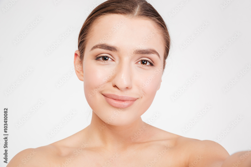 Beauty portrait of charming smiling young woman taking selfie Beauty portrait of charming smiling young woman taking selfie