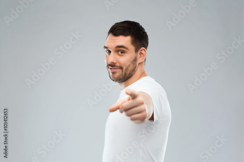 man pointing finger to you over gray background