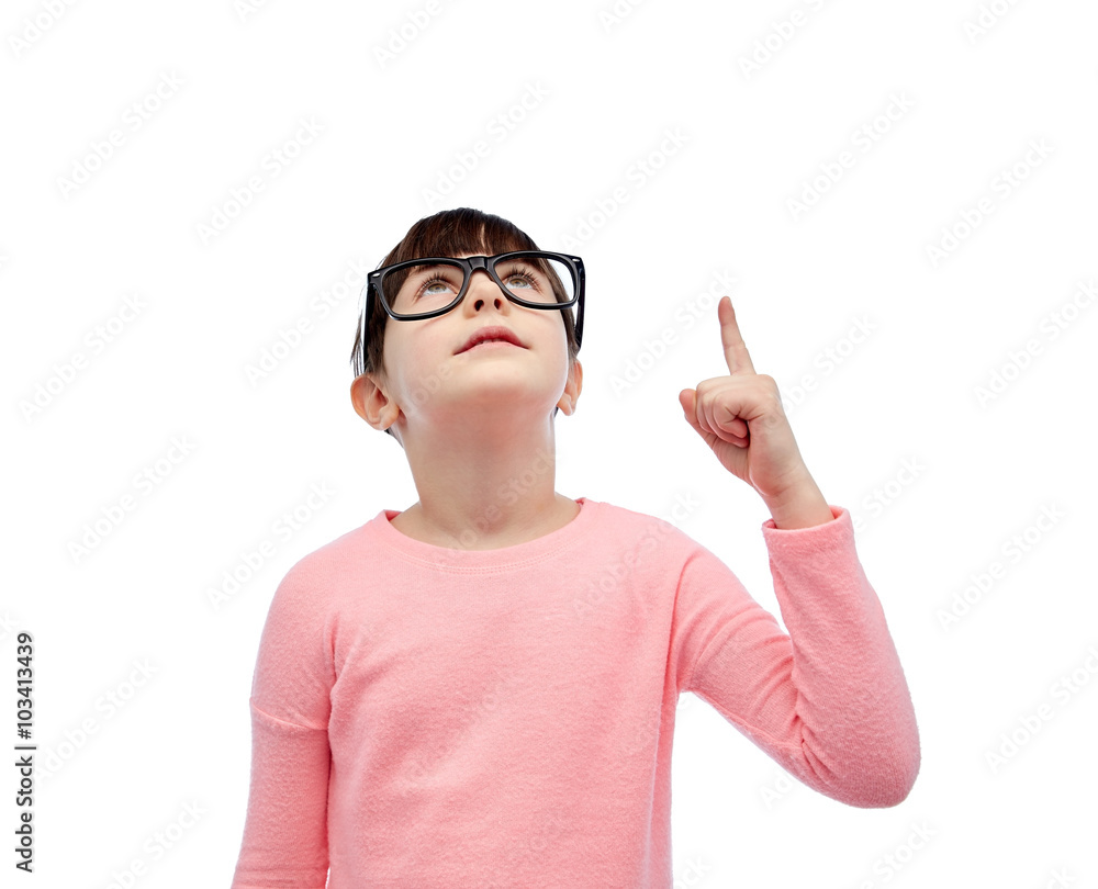 happy little girl in eyeglasses pointing finger up happy little girl in eyeglasses pointing finger up