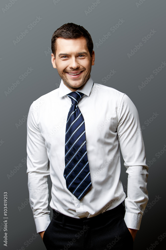 Handsome stylish businessman on grey background Handsome stylish businessman on grey background