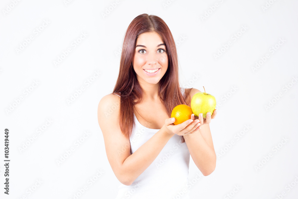 Happy smilling woman with orange and apple in hands. Healthy lifestyle. Happy smilling woman with orange and apple in hands. Healthy lifestyle.
