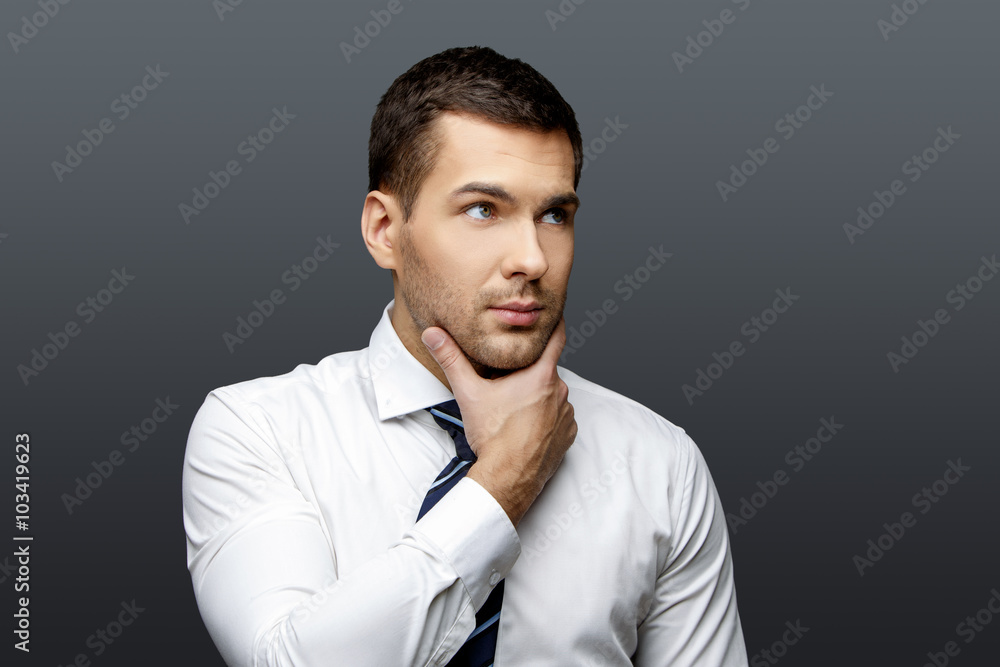 Handsome stylish businessman on grey background Handsome stylish businessman on grey background