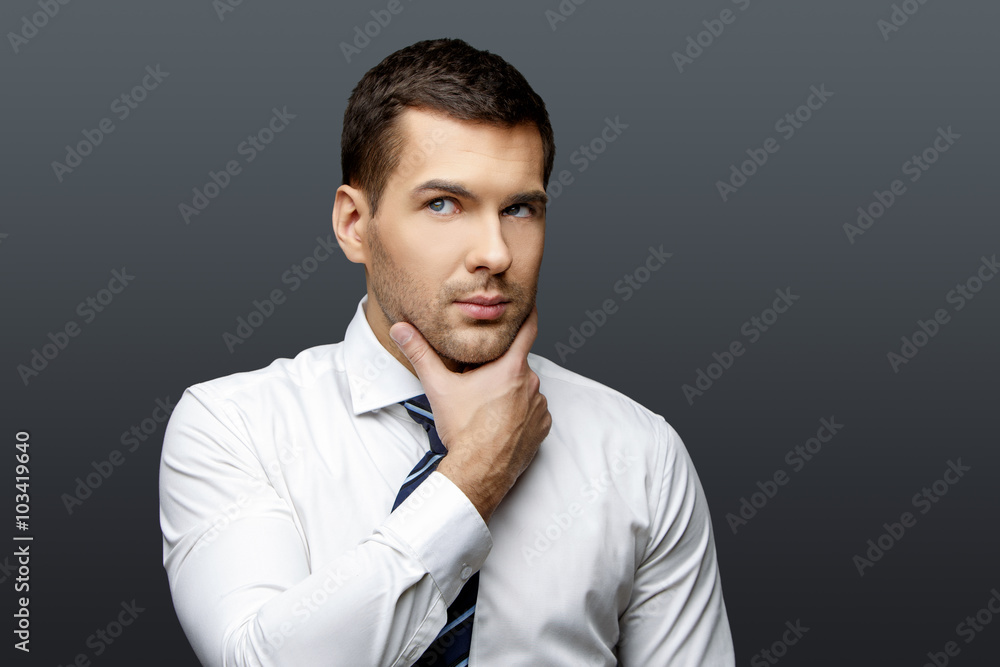 Handsome stylish businessman on grey background Handsome stylish businessman on grey background