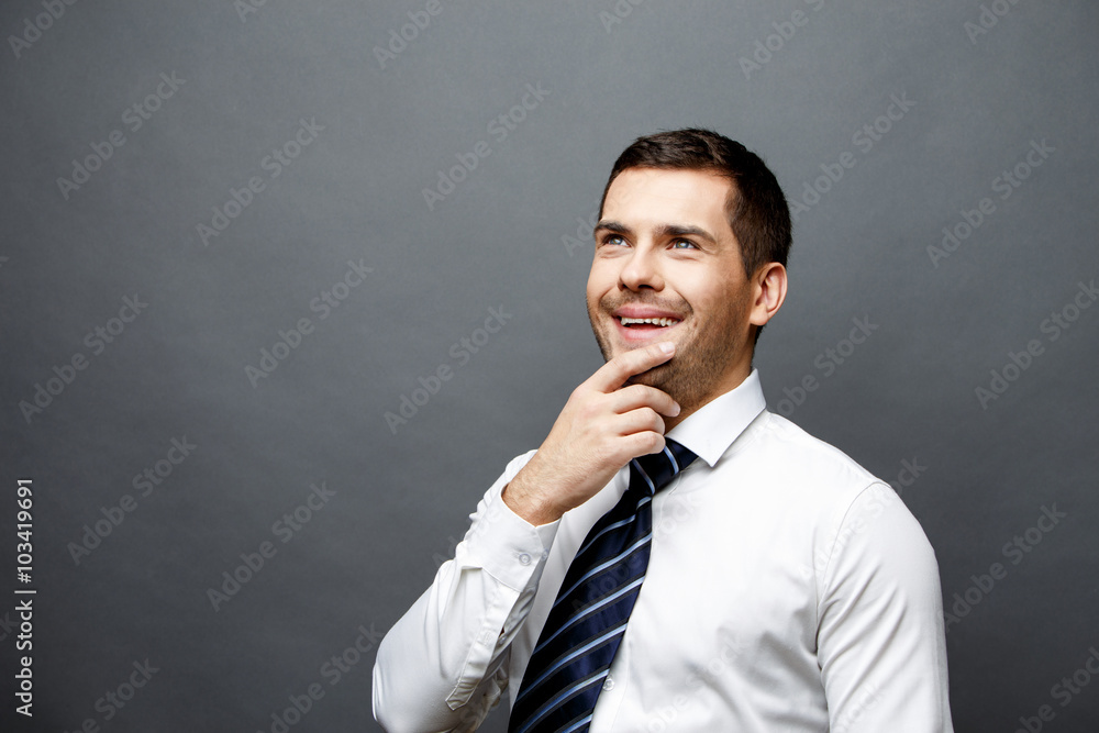 Handsome stylish businessman on grey background Handsome stylish businessman on grey background