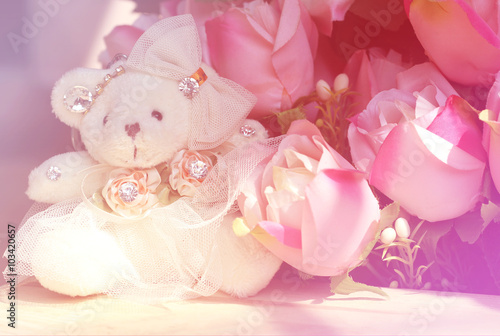 Fototapeta Naklejka Na Ścianę i Meble -  Teddy bear girl white with pink roses bunch, soft focus.