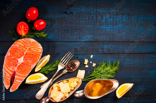 Composition with fresh salmon, herbs, parmesan and spices. Food background. Space for text 