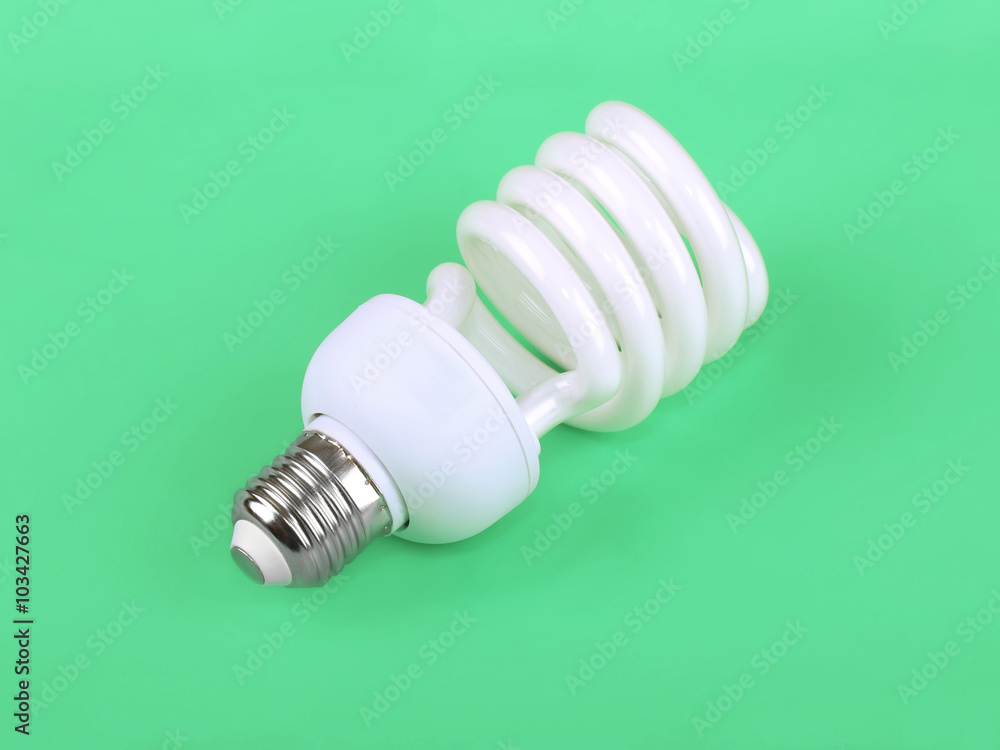 Energy saving fluorescent light bulb on green background Energy saving fluorescent light bulb on green background