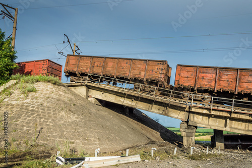 Destroyed bridge with wagons