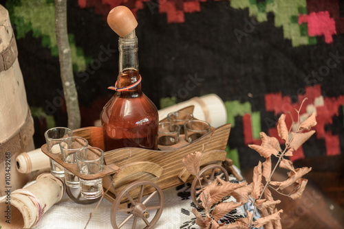 Homemade brandy in a small bottle and small glasses