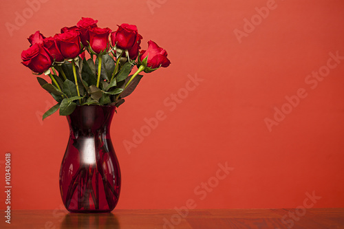 Red roses in vase on red background, Valentines Day