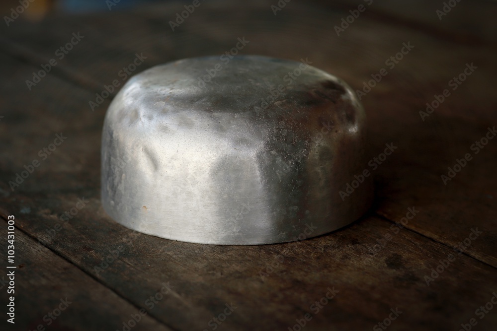 stainless steel bowl on wooden background