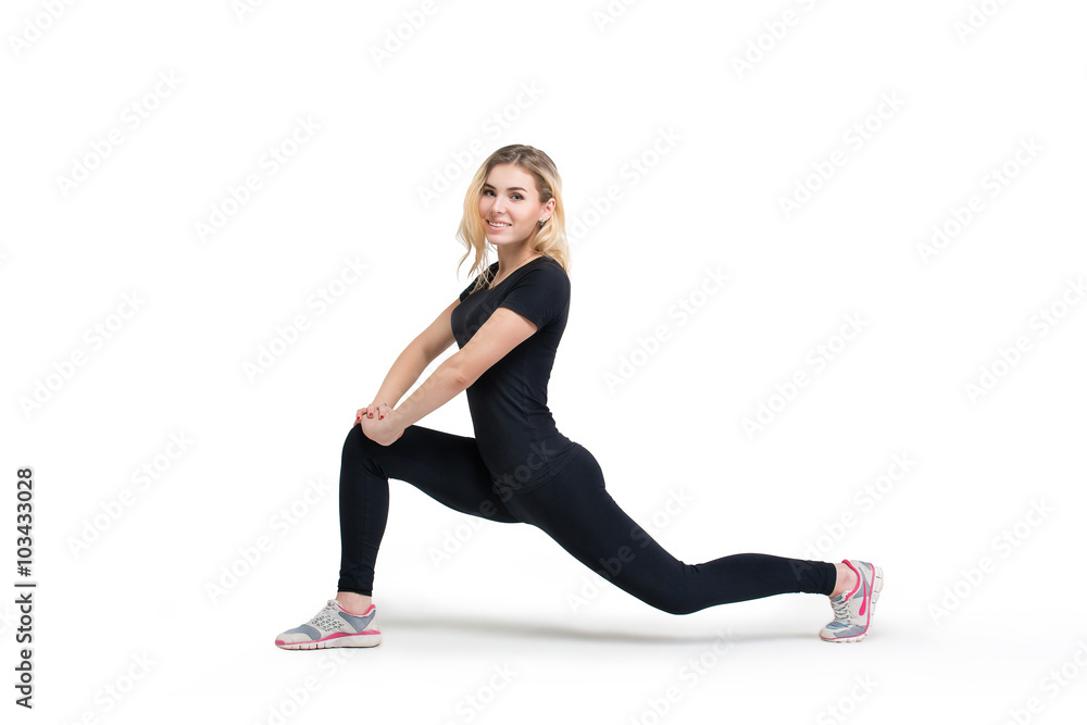 Woman doing fitness forward lunge isolated at white