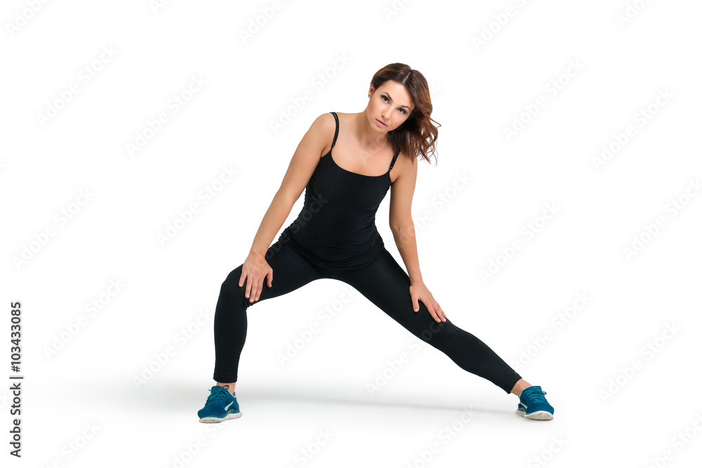 Young woman doing stretching before training isolated Young woman doing stretching before training isolated