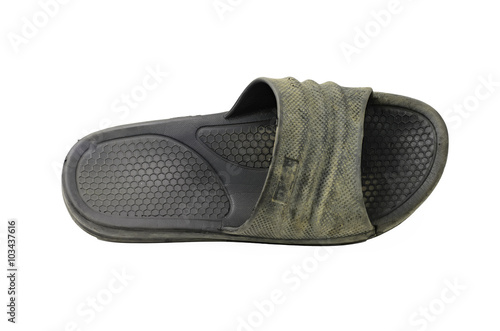 Used dirty black rubber sandal on white background