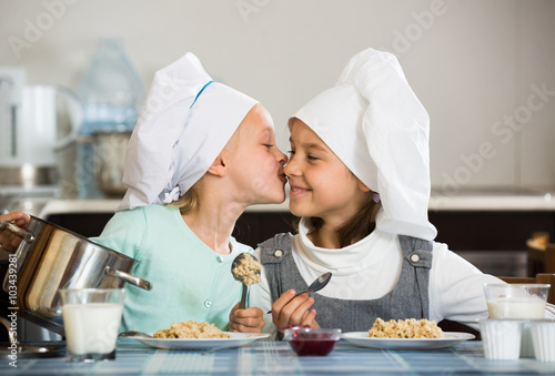 girls having breakfast with porridge