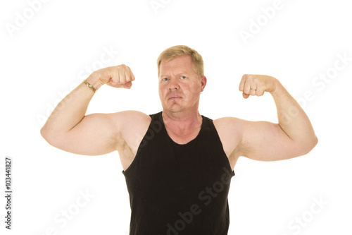 man in black tank flexing