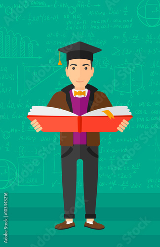 Man in graduation cap holding book.