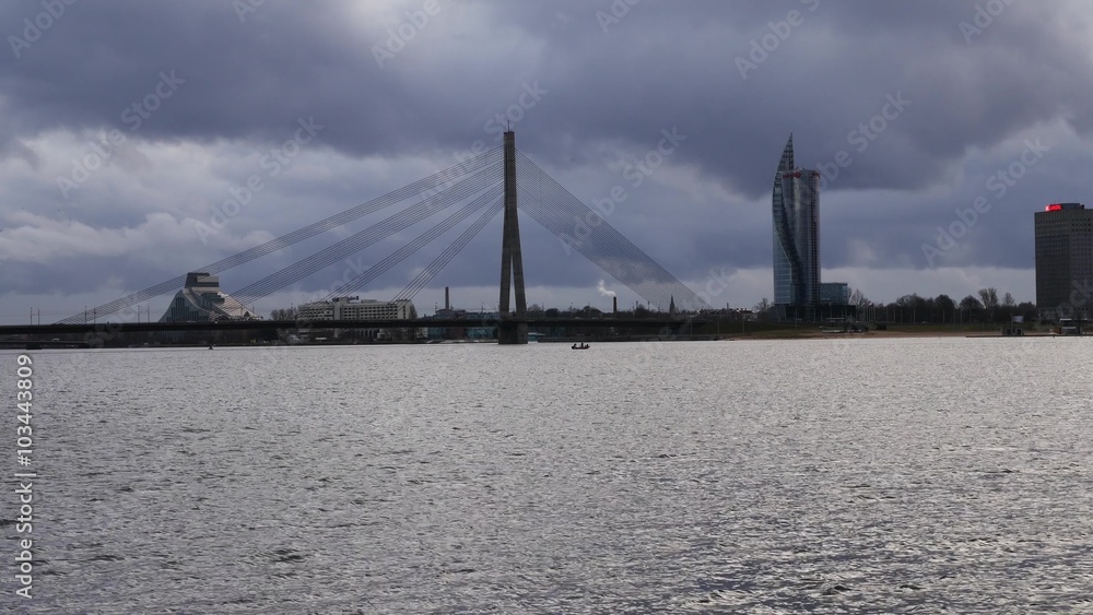 Riga, Latvia. The view to cable stayed bridge and Sun Stone from Kipsala island. Daugava river. Riga, Latvia. The view to cable stayed bridge and Sun Stone from Kipsala island. Daugava river.
