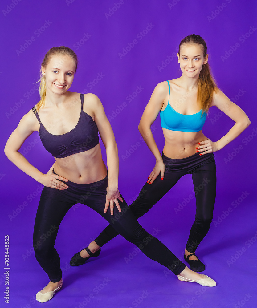 two women on fitness doing gymnastic exercises two women on fitness doing gymnastic exercises