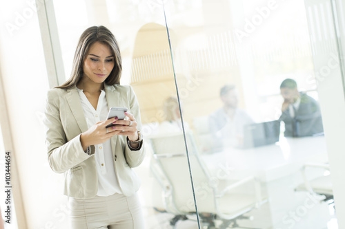 Young woman with mobile pho...