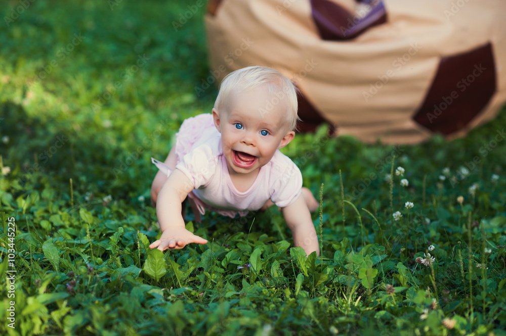 Smiling portrait cute baby-girl on green grass Smiling portrait cute baby-girl on green grass