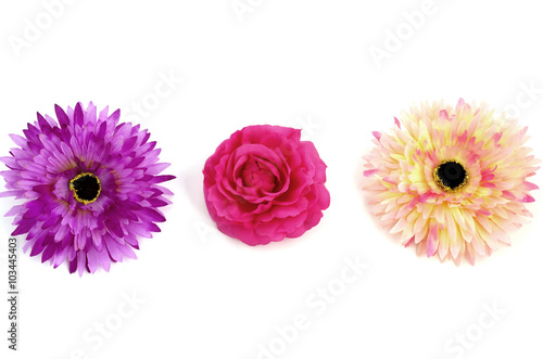 Floristics - droped artificial flowers on white background photo