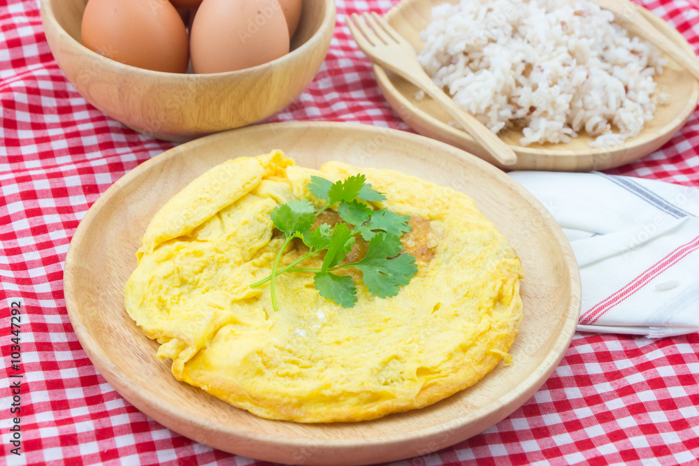 Omelet in wooden dish on set table Omelet in wooden dish on set table
