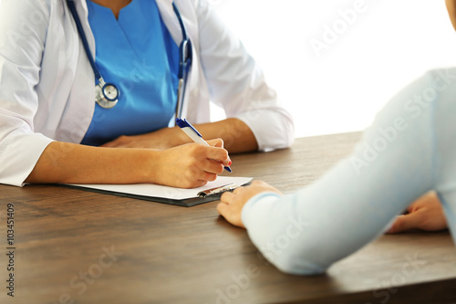 Male patient visiting doctor on light background