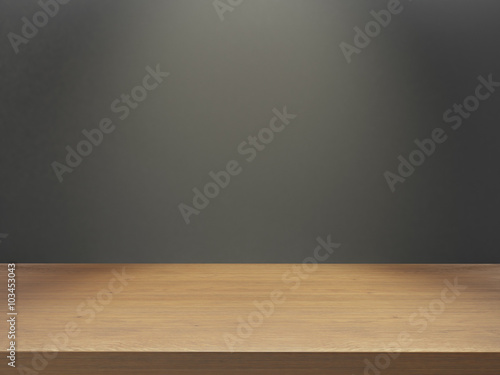 wooden desk with gray wall under light effect