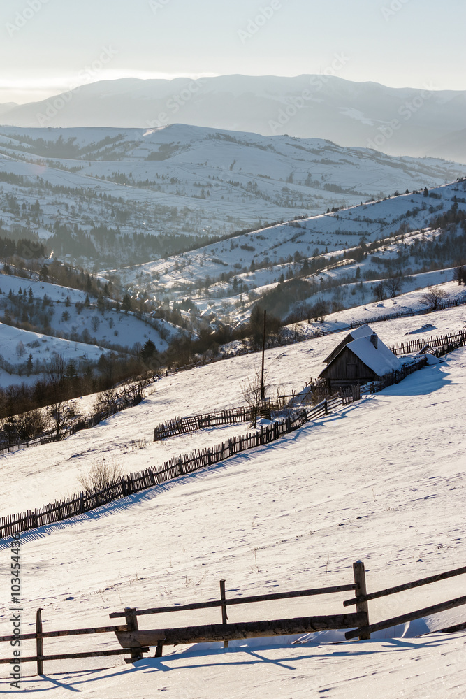 woodshed on the hillside in winter mountains woodshed on the hillside in winter mountains