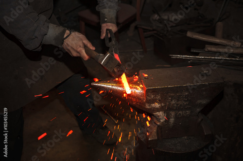 Blacksmith forfing hot iron