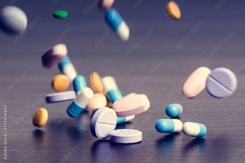 Pharmacy background on a dark table. Levitation pills. Tablets on a dark background which falling down. Pills. Medicine and healthy. Close up of capsules. Differend kind of pills Pharmacy background on a dark table. Levitation pills. Tablets on a dark background which falling down. Pills. Medicine and healthy. Close up of capsules. Differend kind of pills