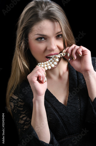 Sweet lady wear a fancy necklace and lacy dress, black background