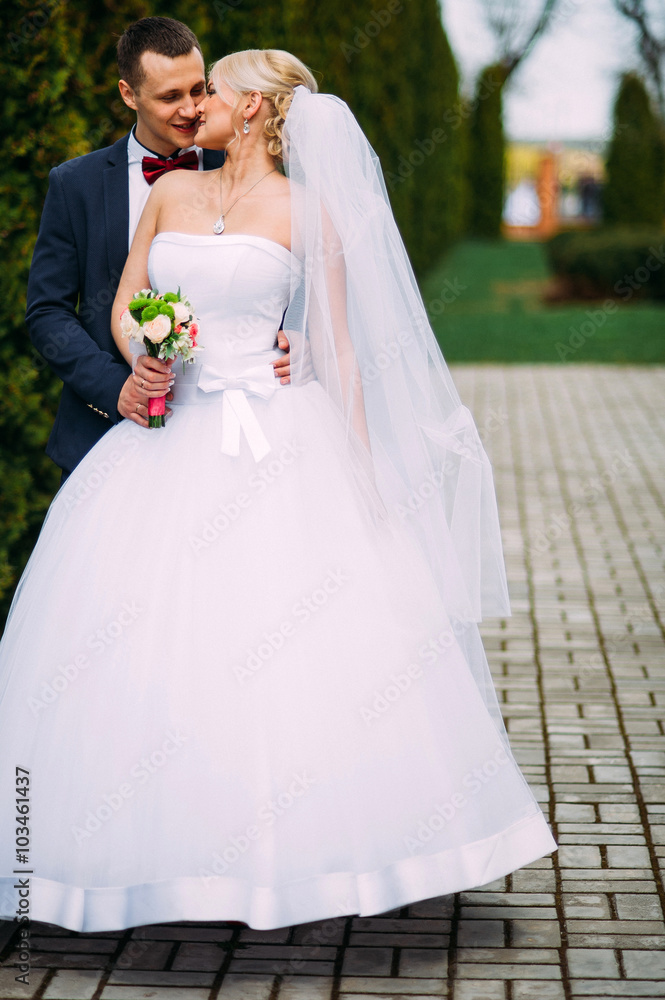 Bride and groom at wedding Day hugging Outdoors on spring nature Bride and groom at wedding Day hugging Outdoors on spring nature