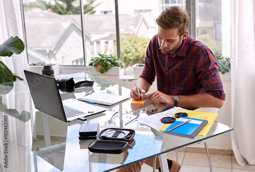 Young caucasian businessman working at his desk