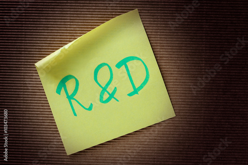 R&D (Research and Development) acronym on yellow sticky note