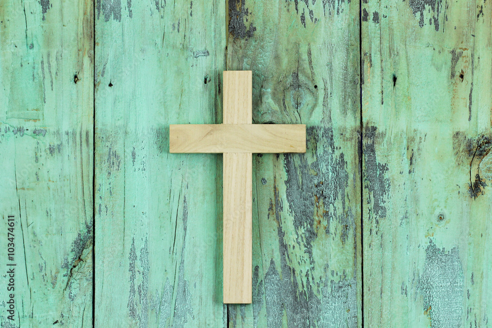 Wood cross hanging on rustic door