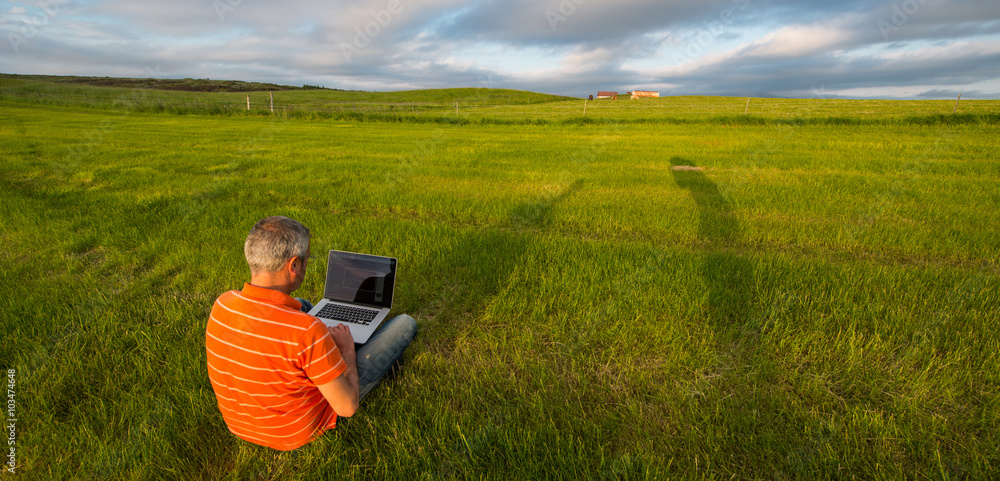 Man at work in the meadow at sunset