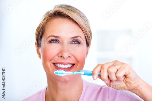 Beautiful senior woman with a toothbrush.