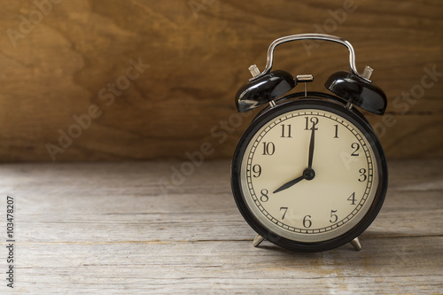 Retro alarm clock on wooden table