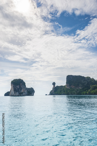 Thailand Chicken Head island cliff over ocean water during tourist boat trip in Railay Beach resort