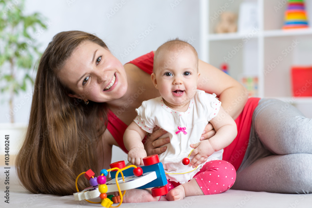 Baby with mom. Mother and daughter indoor. Little girl and woman play together. Baby with mom. Mother and daughter indoor. Little girl and woman play together.