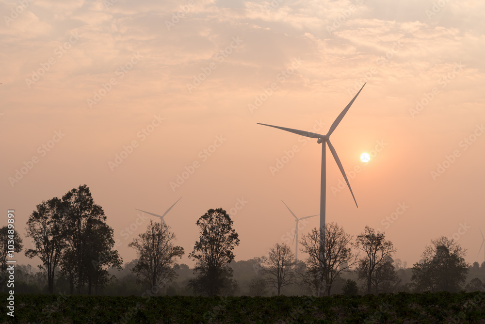 silhouette of wind turbines at sunset silhouette of wind turbines at sunset