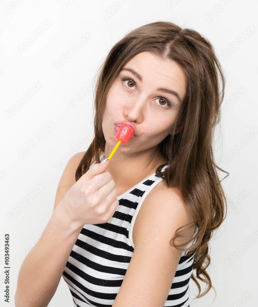 beautiful slim girl in black shorts and a striped top, eating candy beautiful slim girl in black shorts and a striped top, eating candy