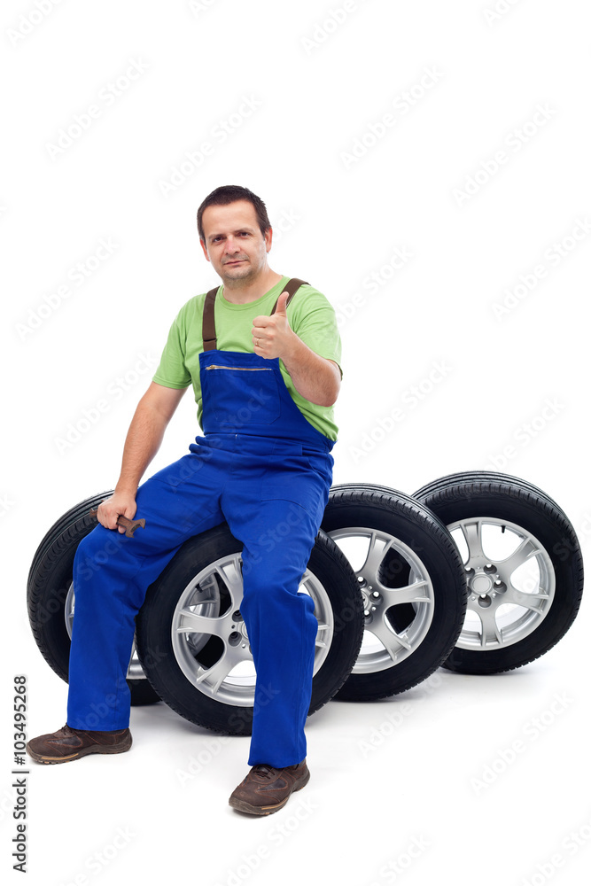 Car mechanic with a set of new tires