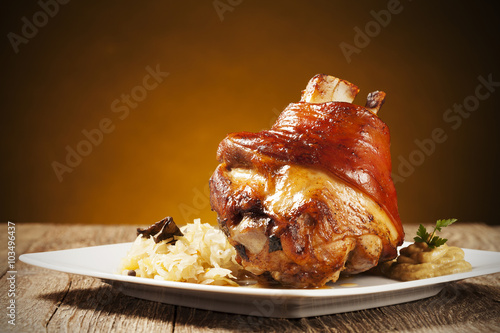 Roast pork knuckle served with boiled cabbage, bread, horseradis