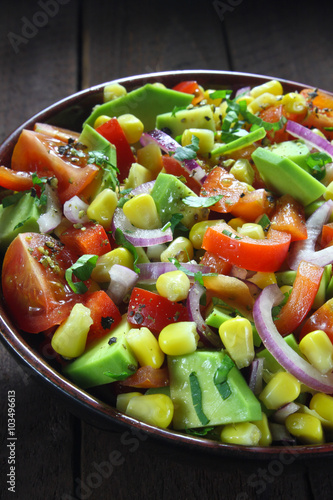 Salad with avocado, tomato, paprika, red onion and corn