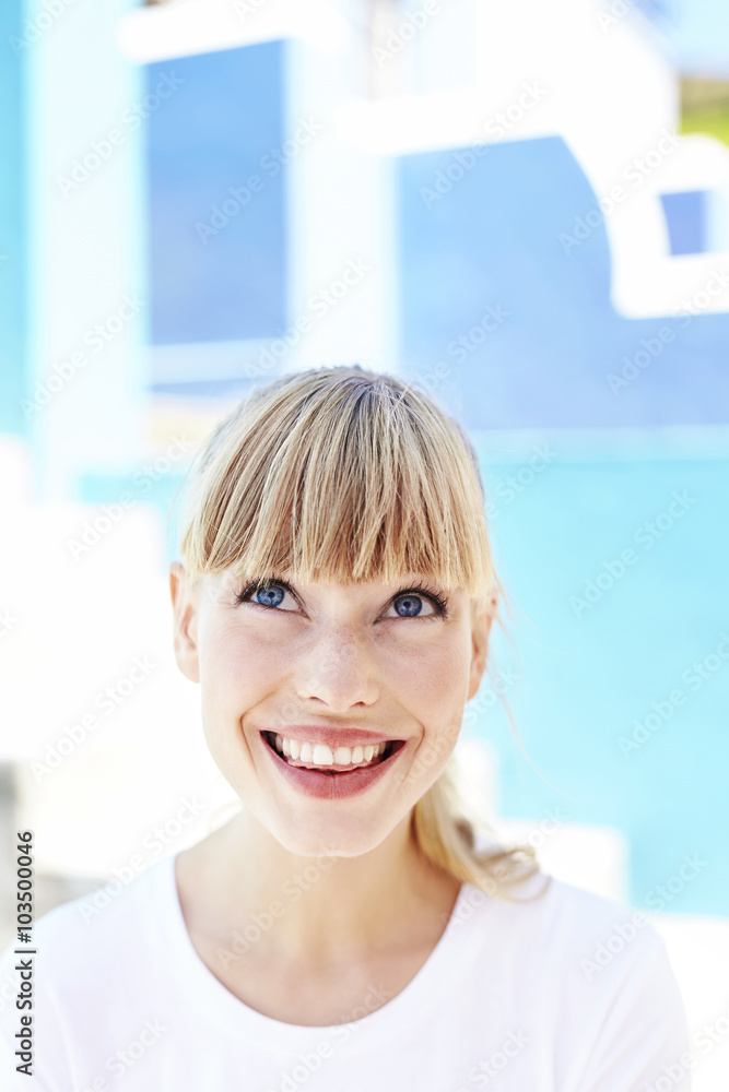 Fototapeta premium Excited young blond woman looking up