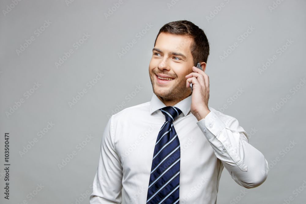 Handsome stylish businessman on grey background Handsome stylish businessman on grey background
