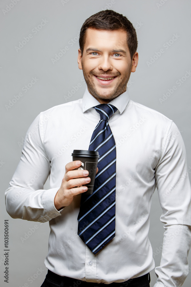 Handsome stylish businessman on grey background Handsome stylish businessman on grey background